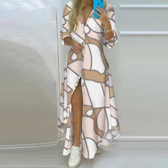 Woman wearing a long sleeve retro print polo neck shirt dress with side slit, ankle length, and single breasted closure in pink, white, and tan.
