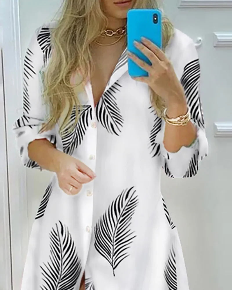 White long sleeve shirt dress featuring black palm leaf print, single breasted buttons, and retro casual style for women.